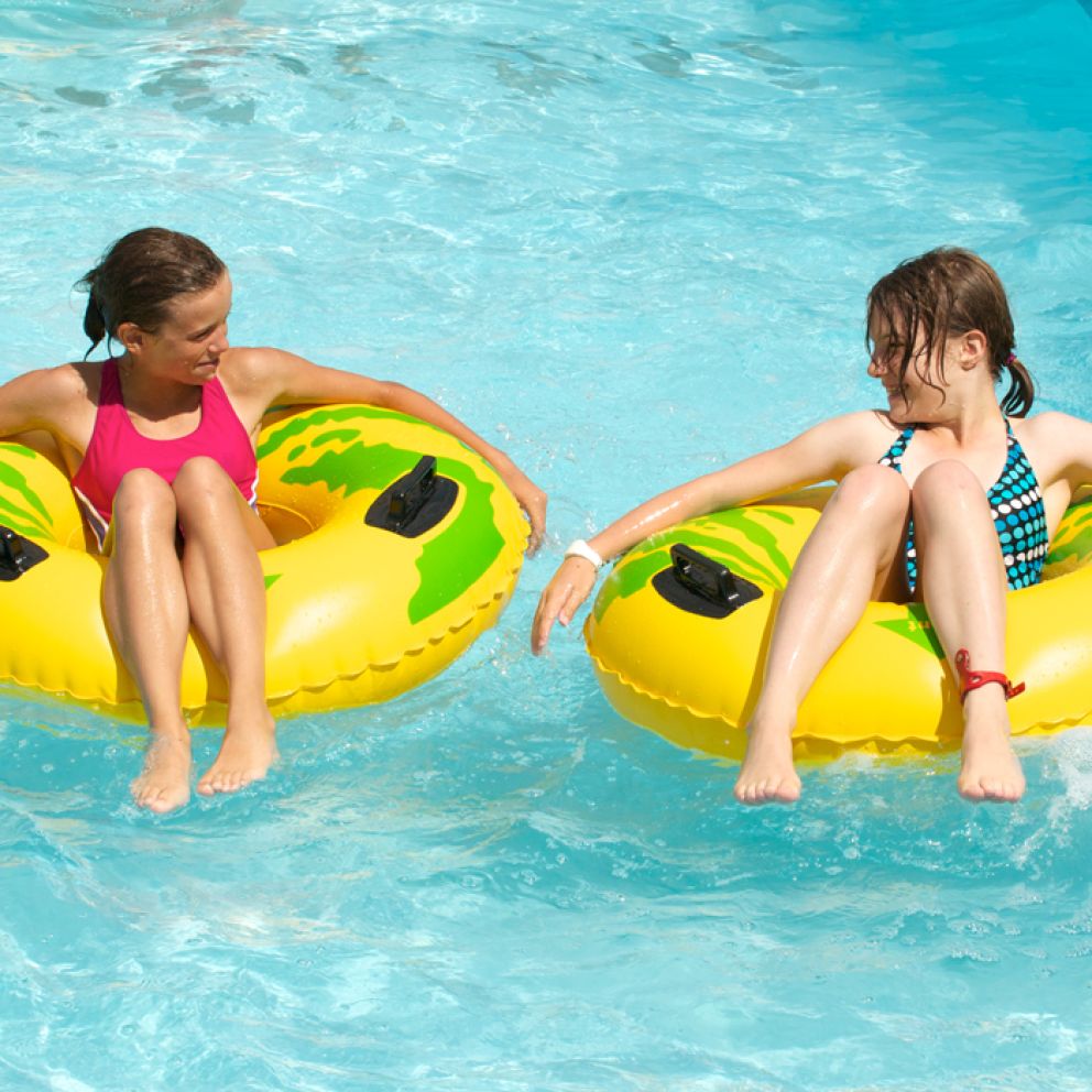 two young people on waterpark tyres